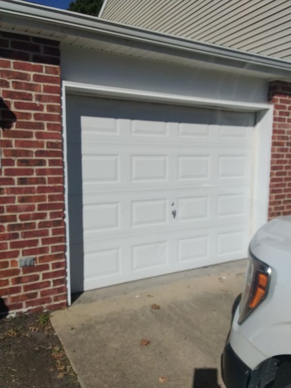 White carriage-style door on brick home