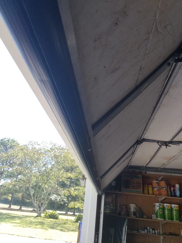 The bottom edge and rubber seal of a garage door photographed on a Seaside service call in Hampton Roads