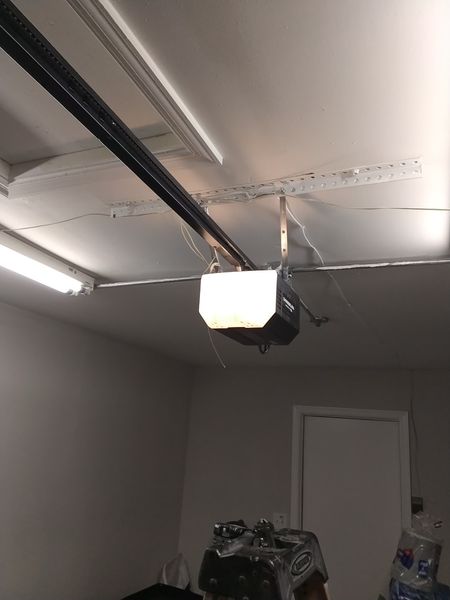 Garage door opener installation in Virginia Beach: a customer-supplied opener mounted to the ceiling and wired by Seaside, September 1, 2026