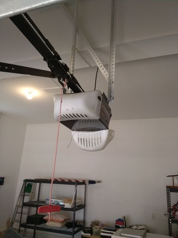Garage door opener repair Williamsburg: the old LiftMaster chain-drive opener in a Ford's Colony garage before removal